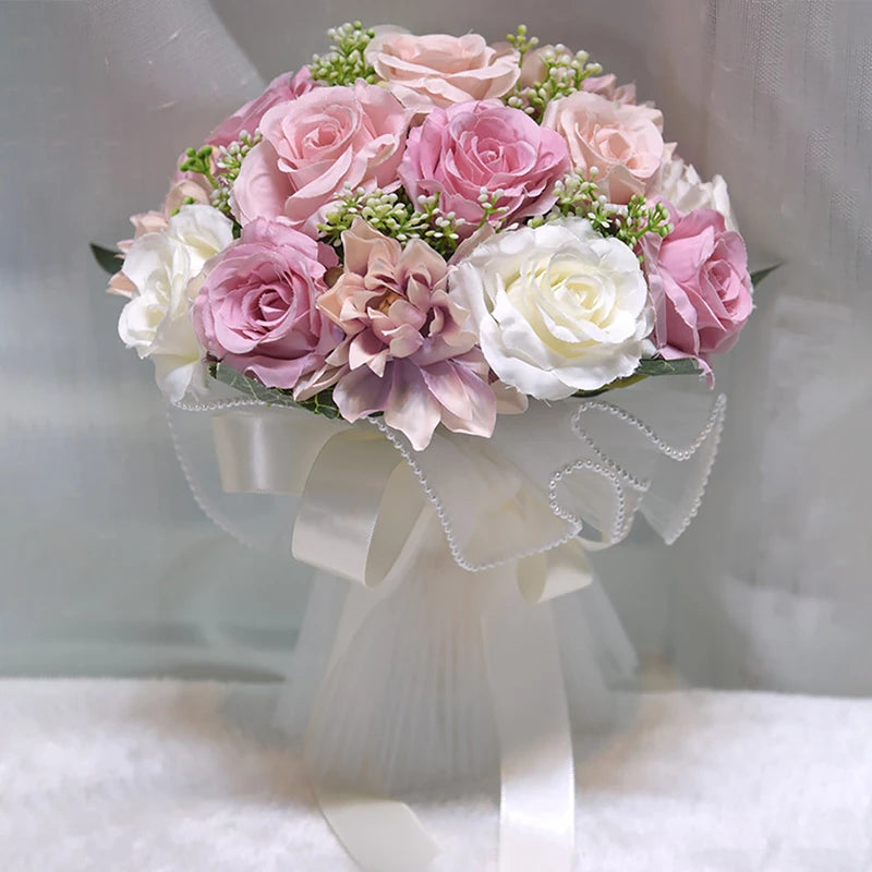 A luxury artificial bridal bouquet featuring a mix of mauve, pink, and white faux flowers accented with green buds and a pearl trim collar.