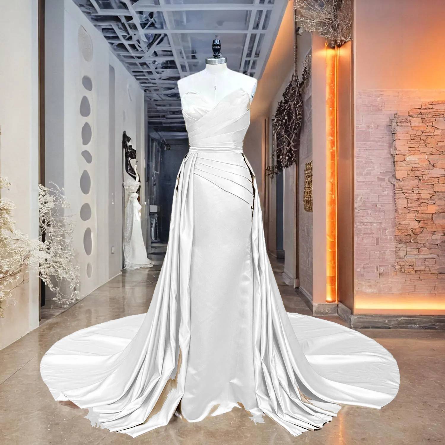 High-key showroom view of a champagne satin 2-piece mermaid bridal dress with a detachable train, highlighting the lustrous fabric and elegant modern tailoring.
