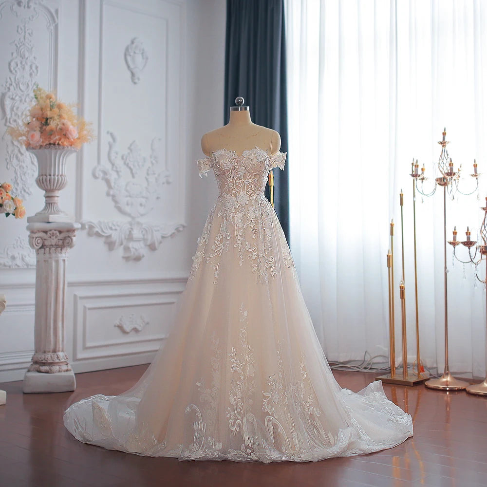 Mannequin display of an elegant off-shoulder A-line wedding dress showcasing the sweetheart neckline and detailed floral lace patterns.