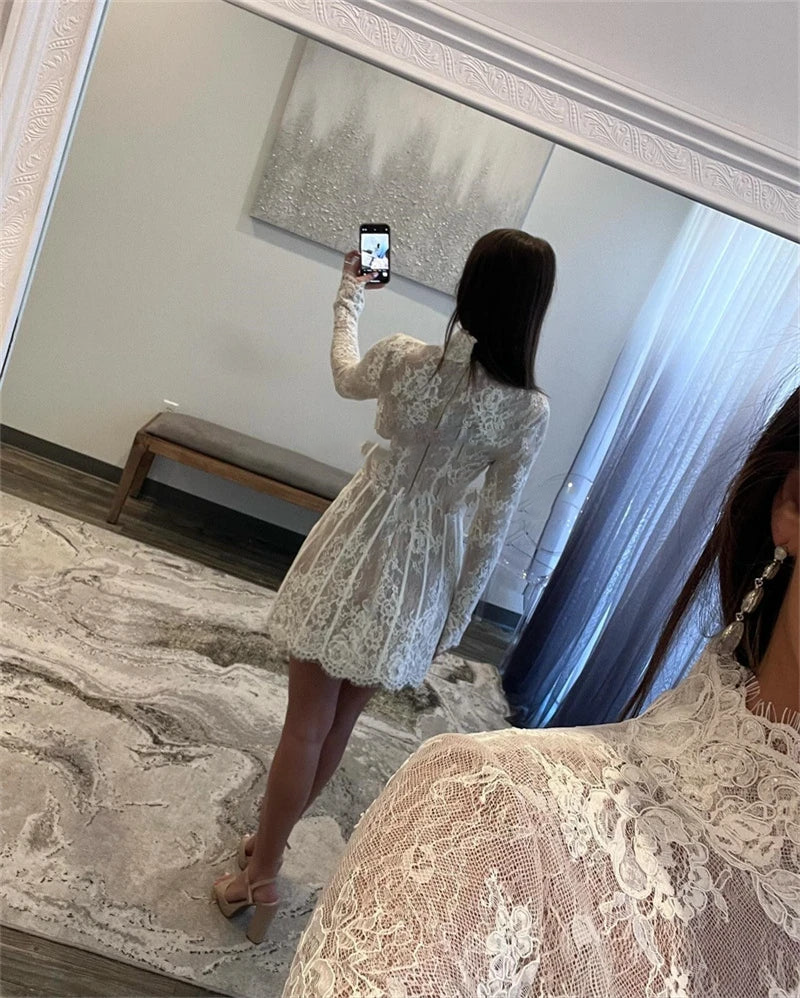 Back view of a charming short lace wedding dress with long sleeves, showcasing a sophisticated high neck and elegant scalloped lace hem.
