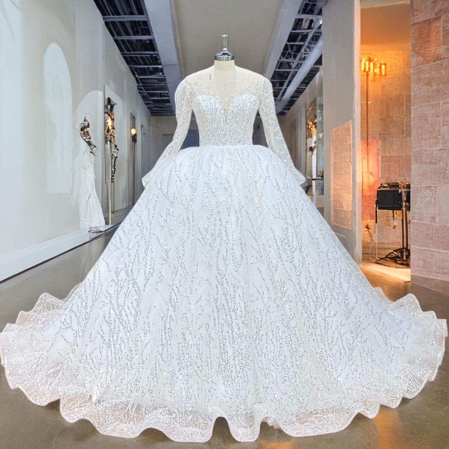 Full length front view of a classic long sleeve lace wedding ball gown with delicate beadwork and a full flowing skirt.