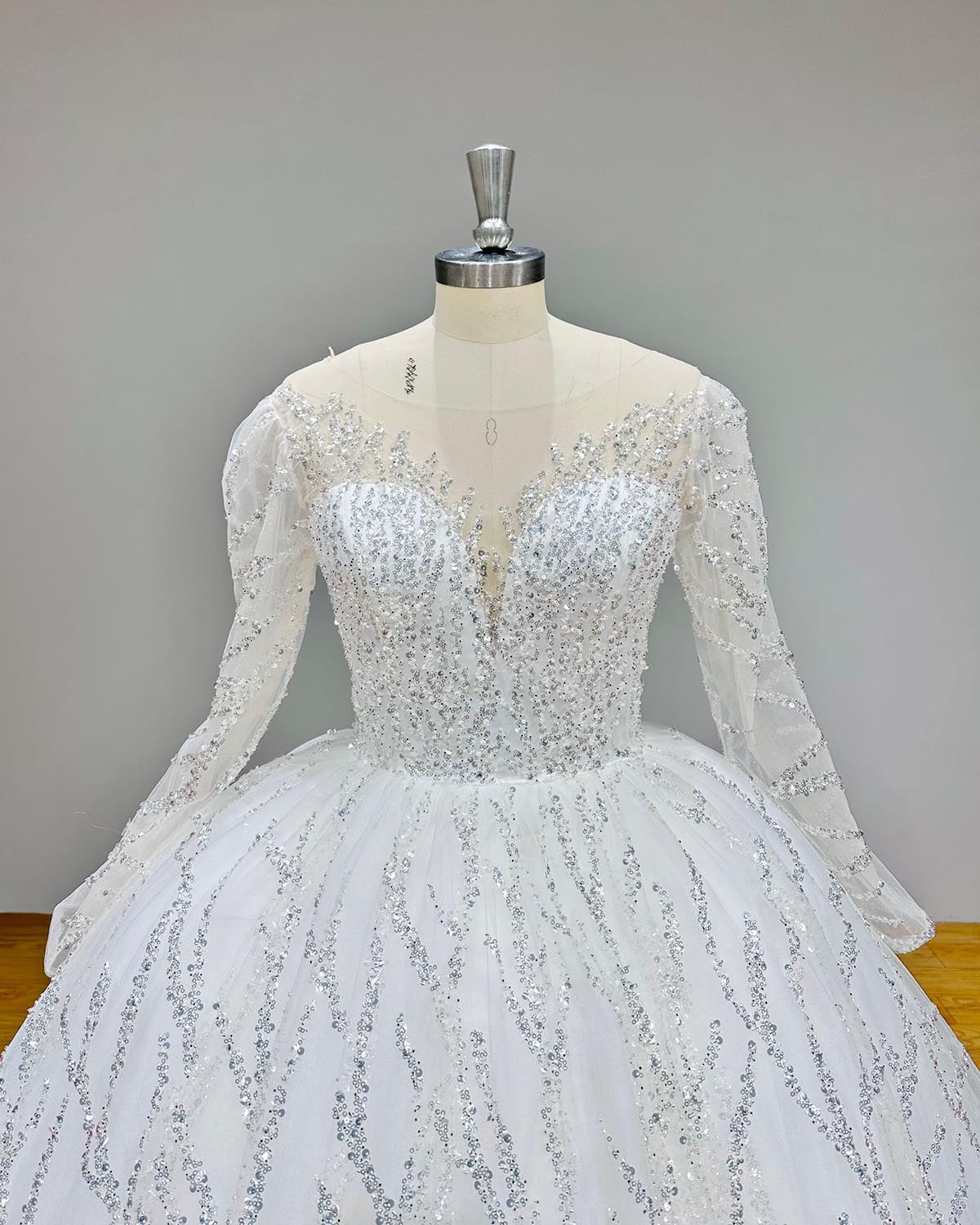 Full length back view of a luxury lace bridal gown showcasing a dramatic train and sophisticated backless design.