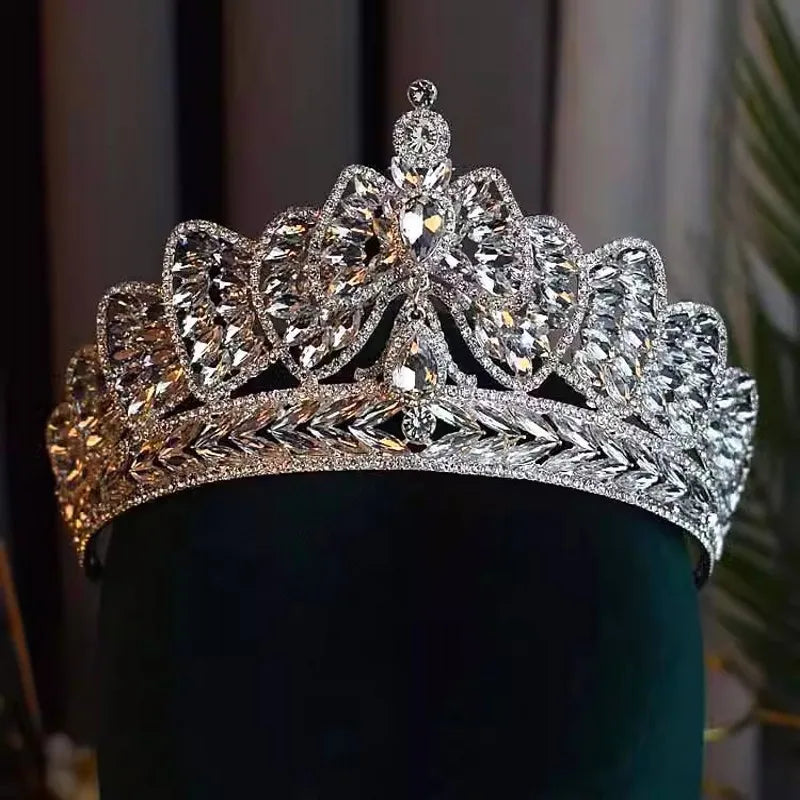 Front view of a regal silver rhinestone wedding headpiece featuring a central bowknot design with layered marquise crystal embellishments.