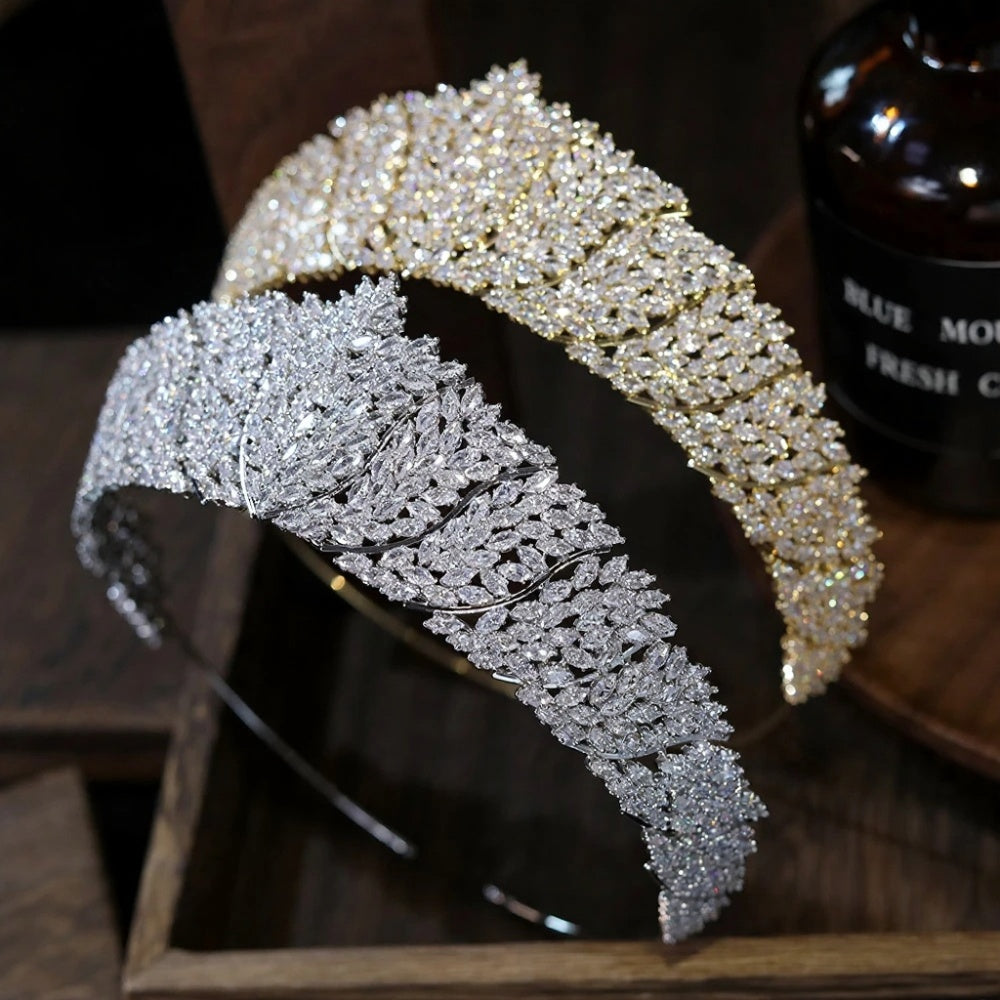 High-angle perspective view of a silver and a gold baroque bridal crown headband highlighting the premium pave rhinestone layout.