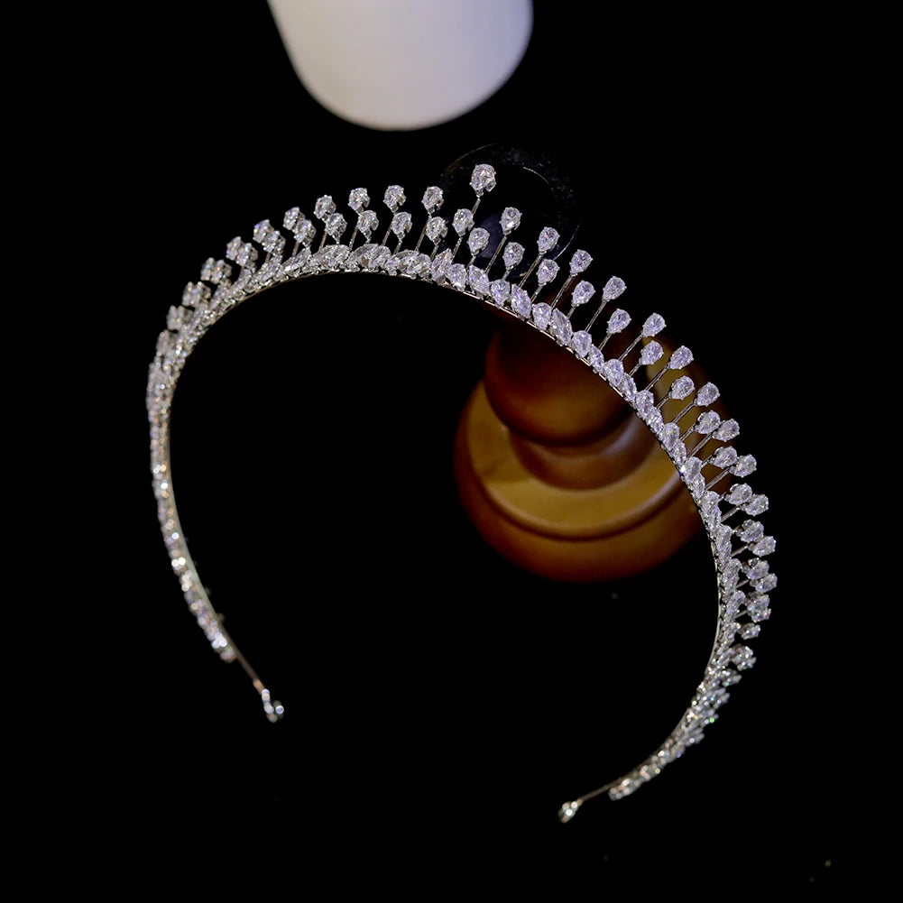 Left-side perspective of an elegant silver crystal tiara headband showcasing spiked vertical rhinestone detailing.