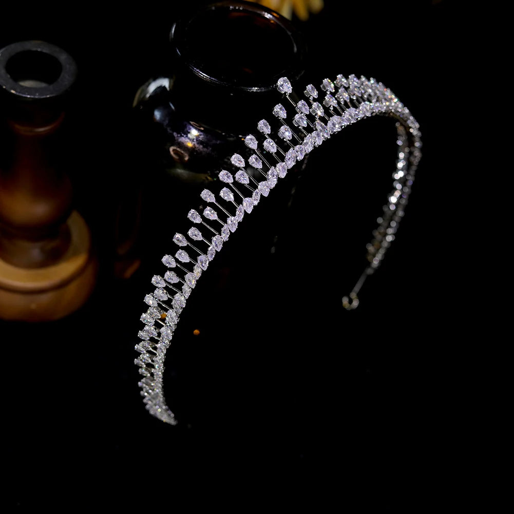 Right-side angle of a delicate crystal princess crown headpiece highlighting the secure silver metal band structure.