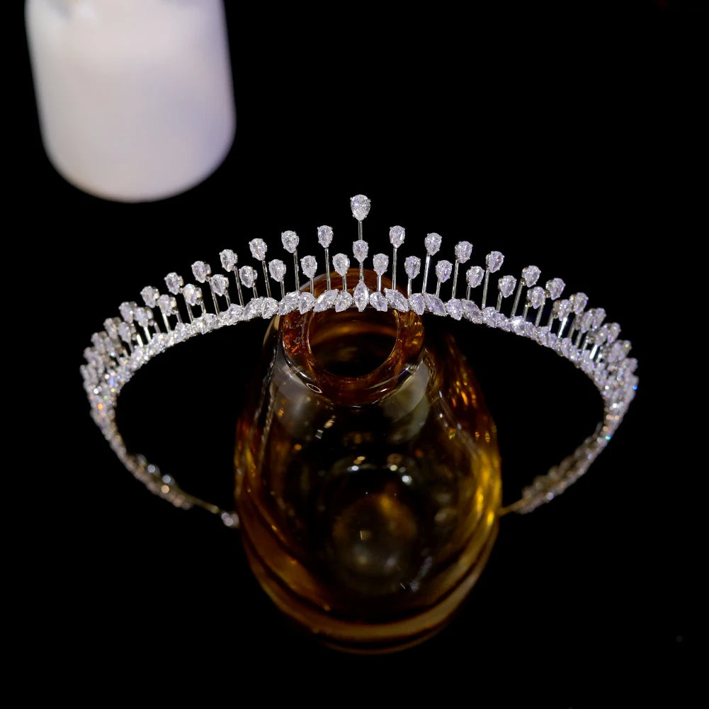 Alternative top-down front view of the premium silver rhinestone wedding tiara crown on a glass jewelry display.