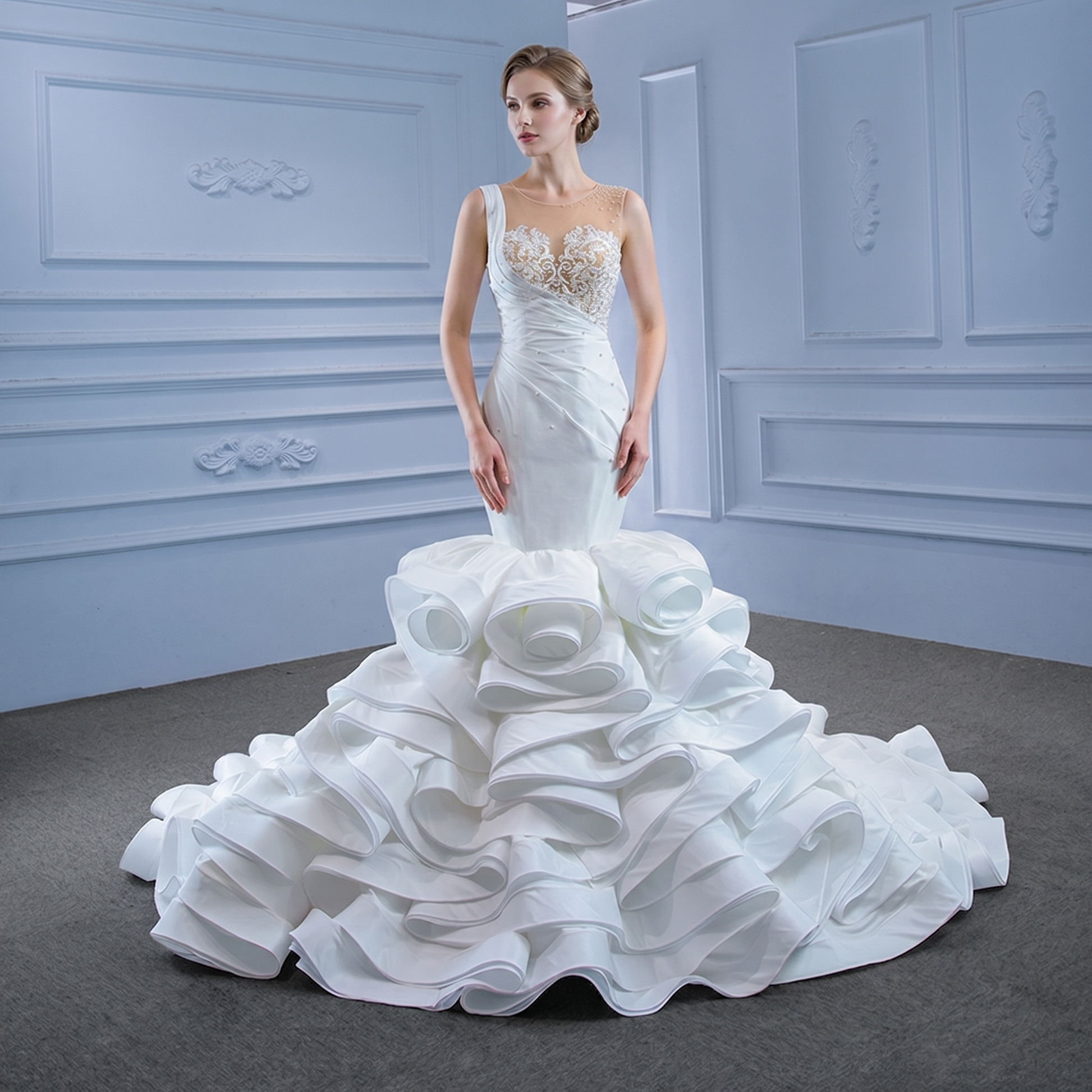 Full-length front view of a model wearing a luxury crystal mermaid wedding dress featuring an intricate pearl lace bodice and a dramatic, voluminous ruffled satin skirt.