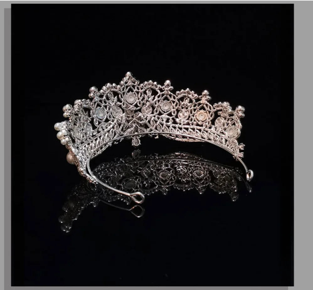 Rear view showing the structural design and silver-tone wire craftsmanship of a pearl bridal crown tiara.