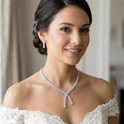 Model wearing a luxury cubic zirconia 2pcs bridal jewelry set featuring a multi-row crossover tennis necklace and matching straight dangle earrings.