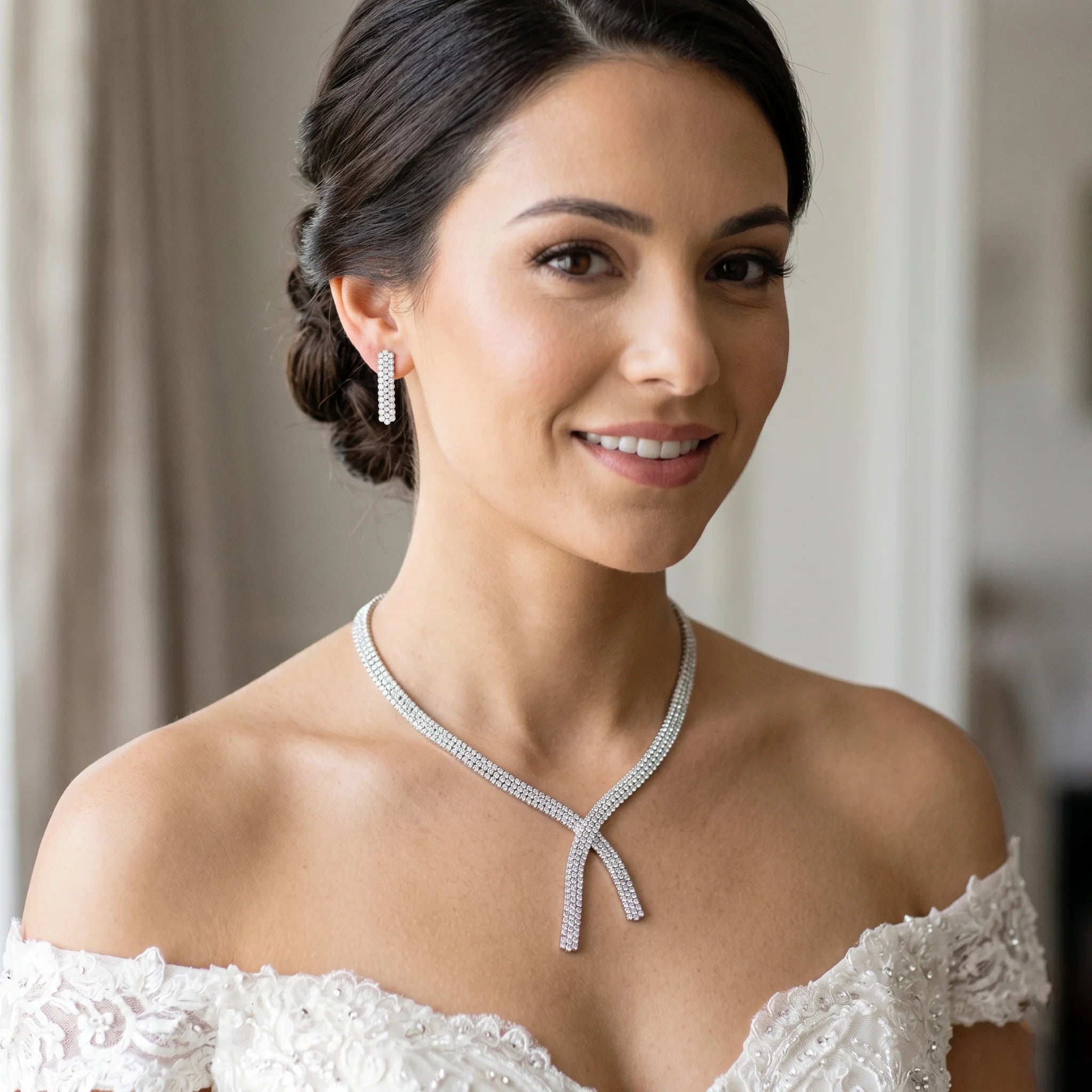 Model wearing a luxury cubic zirconia 2pcs bridal jewelry set featuring a multi-row crossover tennis necklace and matching straight dangle earrings.