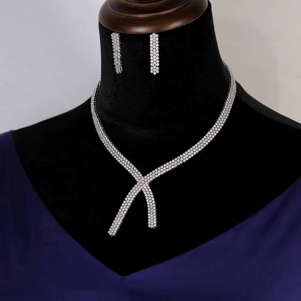 Front profile view of the premium silver cubic zirconia wedding necklace and dangle earring set displayed on a black velvet jewelry bust.