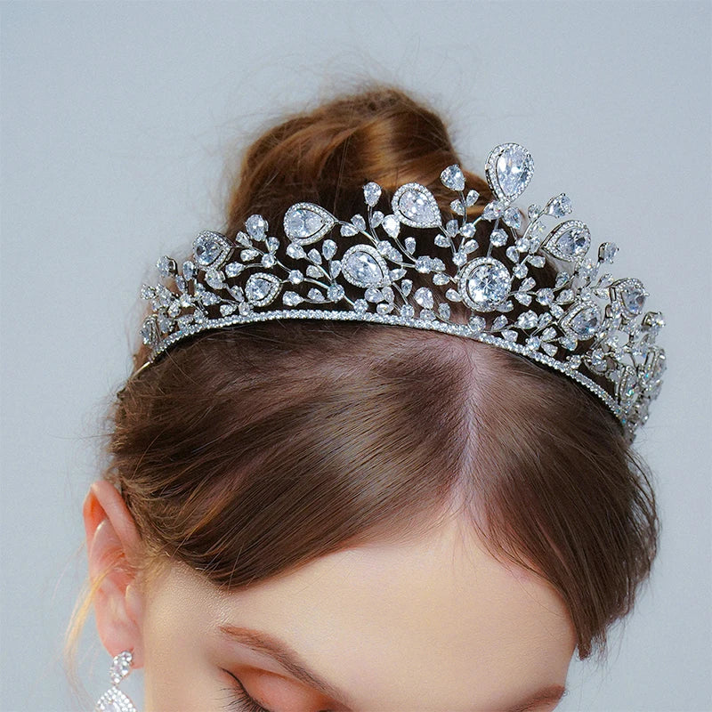 Close-up of a model wearing a luxury cubic zirconia bridal tiara with elegant teardrop crystal accents for wedding hair styling.
