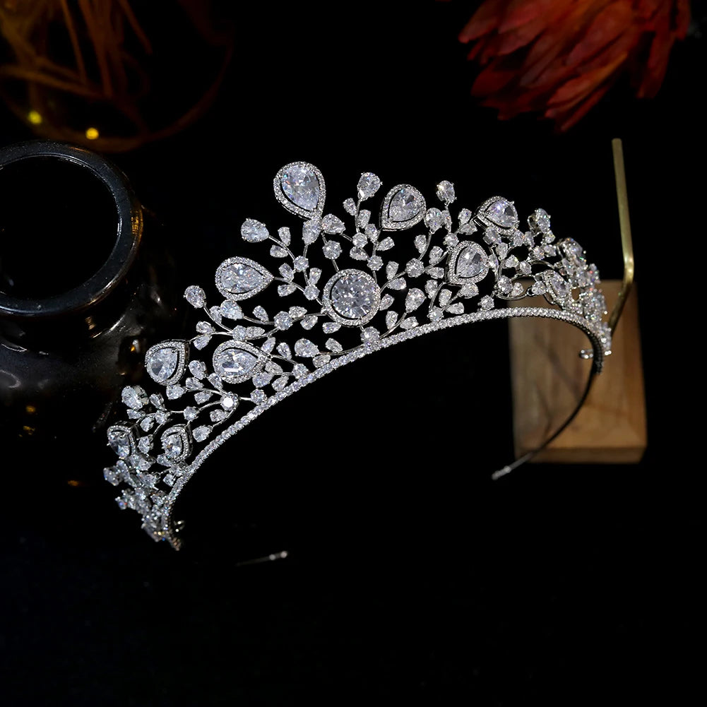 Side-angle view showcasing the intricate pave crystal branches and teardrop diamonds of a silver bridal crown hairband.