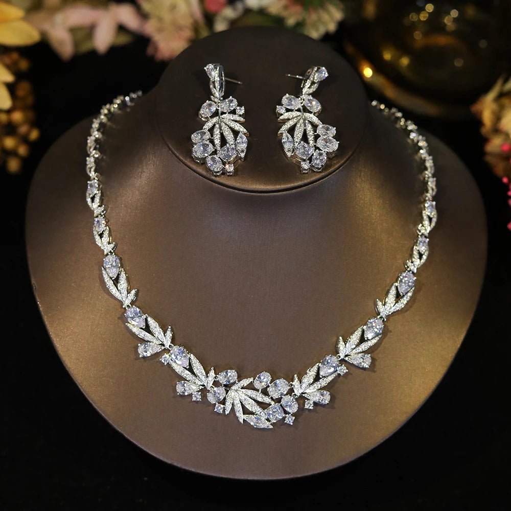 Direct front view of a sparkling cubic zirconia wedding necklace and earring set displayed on a dark jewelry bust.