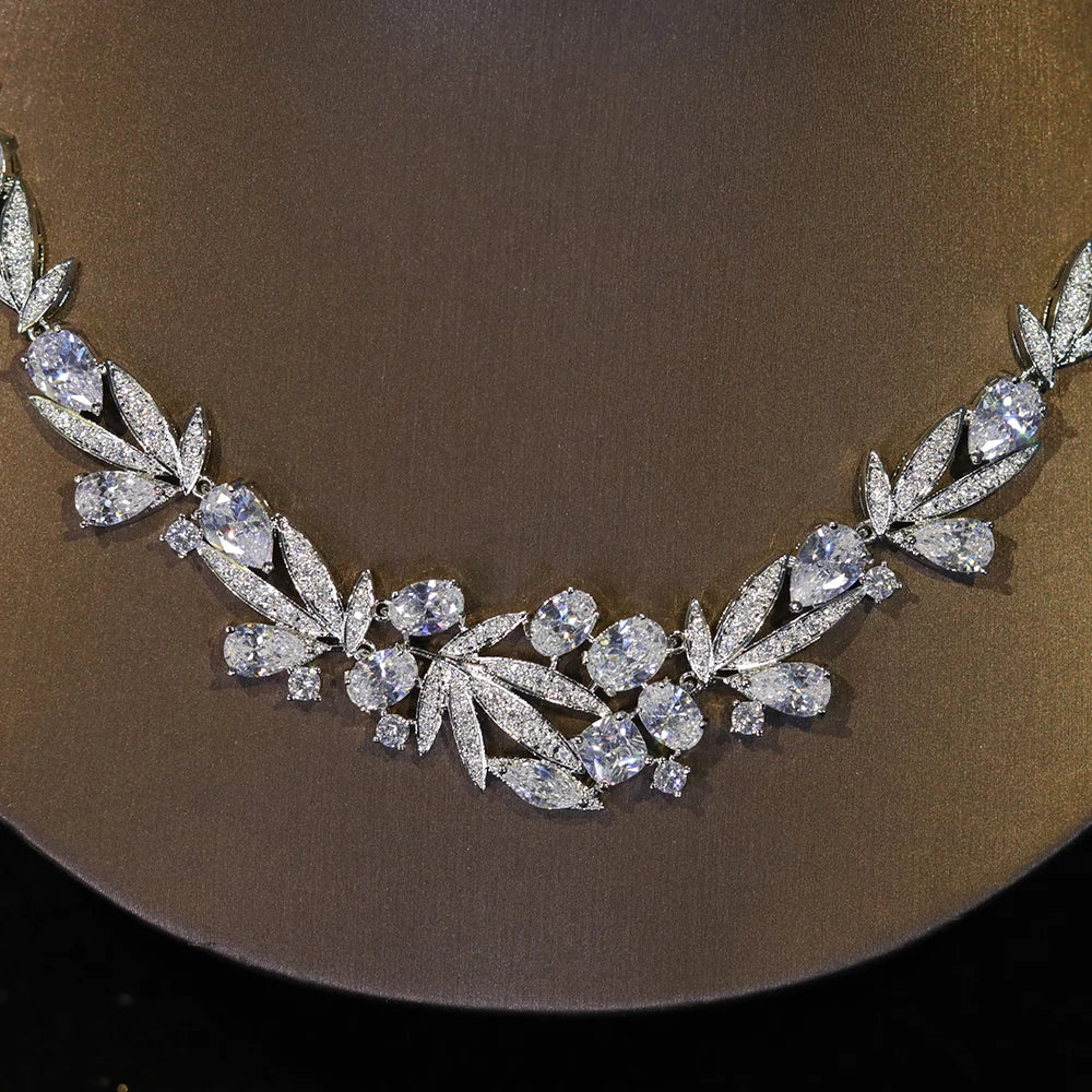 Close-up macro shot showing the detailed marquise cuts and intricate stone setting of a silver cubic zirconia bridal necklace.