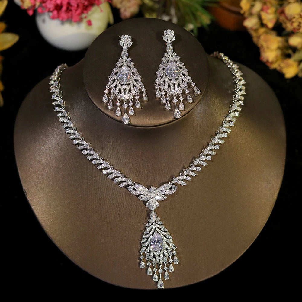 Sparkling silver crystal dangle tassel bridal necklace and earring set displayed on a jewelry bust