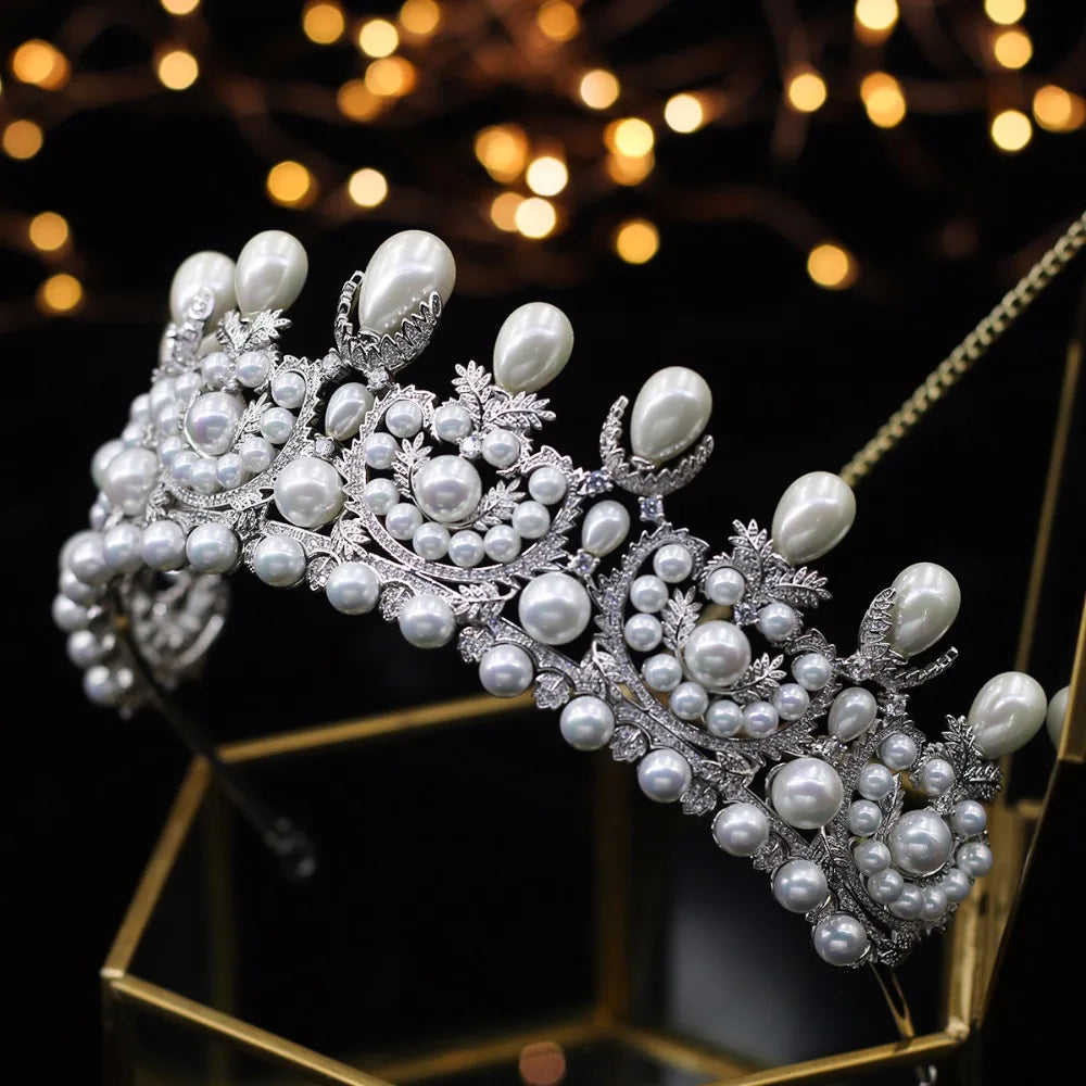 Side-perspective display of an elegant royal princess tiara headband resting on a gold geometric display stand with a soft bokeh backdrop.