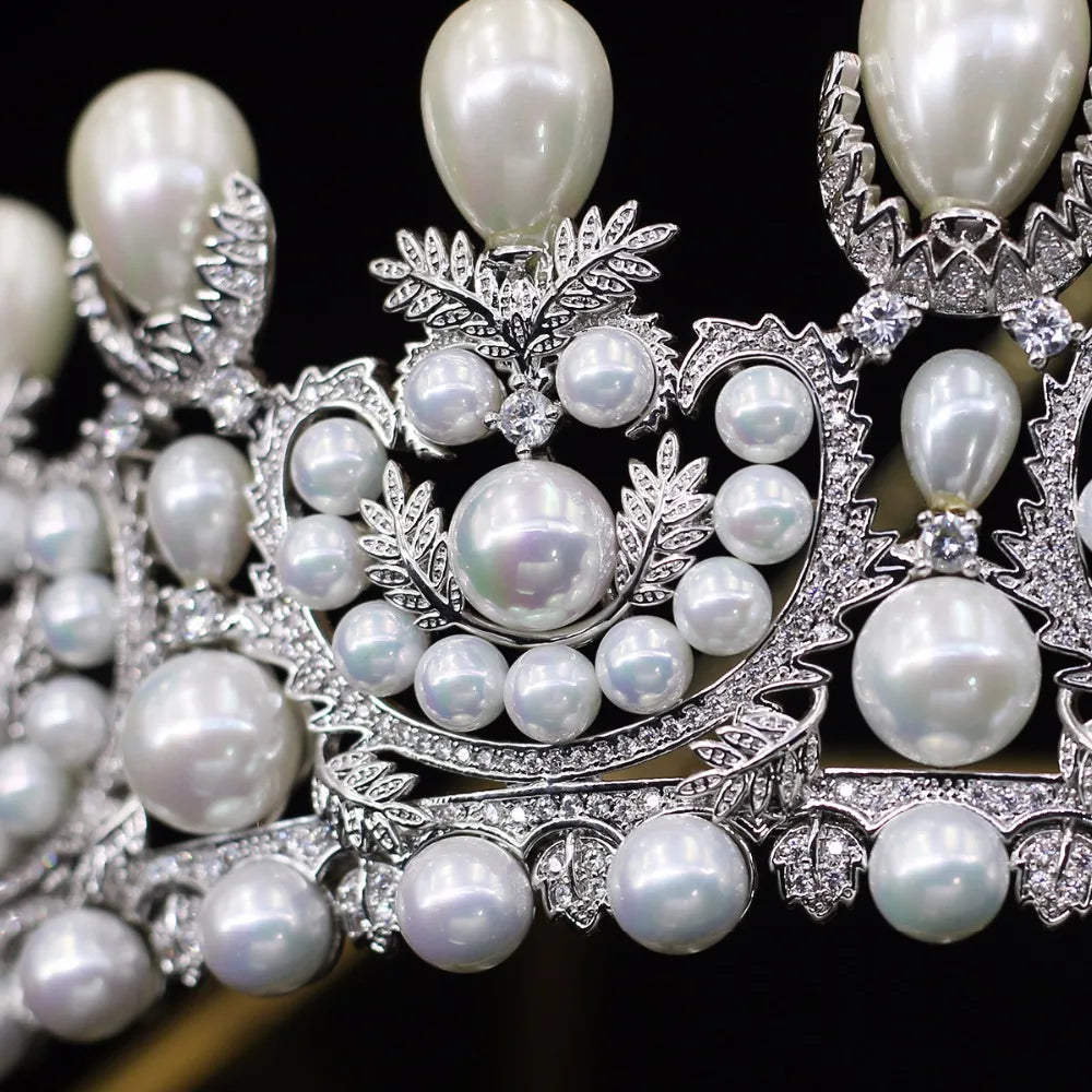 Extreme macro photograph focusing on the flawless pave stone settings and iridescent round pearls of a premium wedding hair accessory.