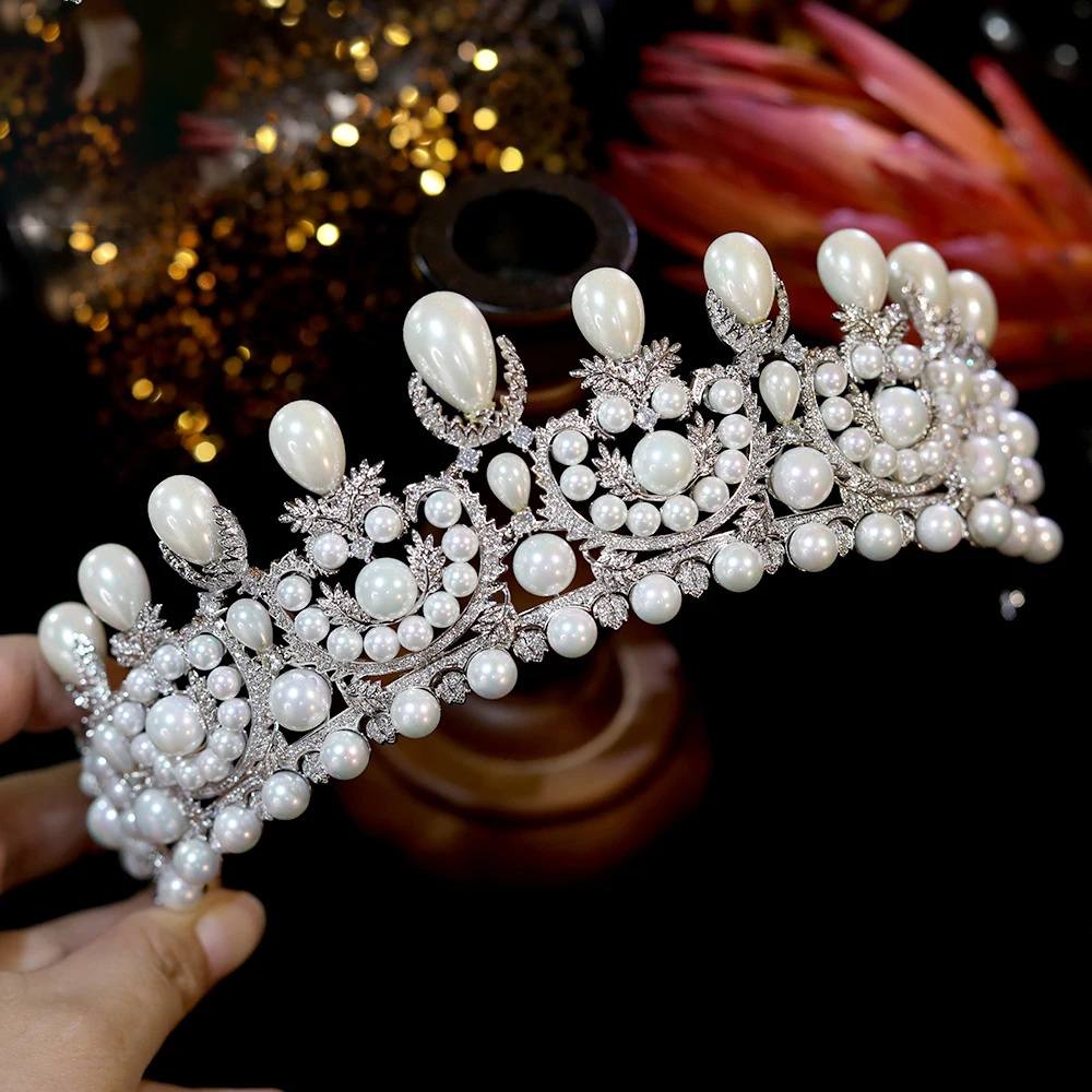 Detailed view from a slightly left angle highlighting the graduated teardrop pearl peaks on a silver-plated queen crown tiara.