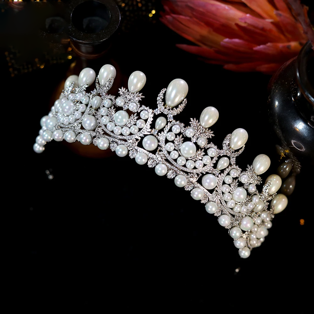 Alternate right side-profile view of the brilliant crystal bridal headpiece, displaying its elegant curved structure against a dark backdrop.