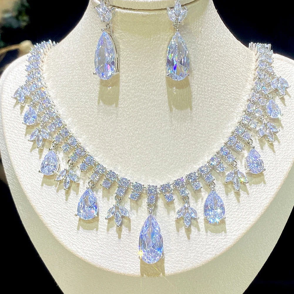 Perspective look highlighting the shimmering multi-faceted properties of a luxury pear-cut droplet crystal bridal jewelry set for wedding or dinner.