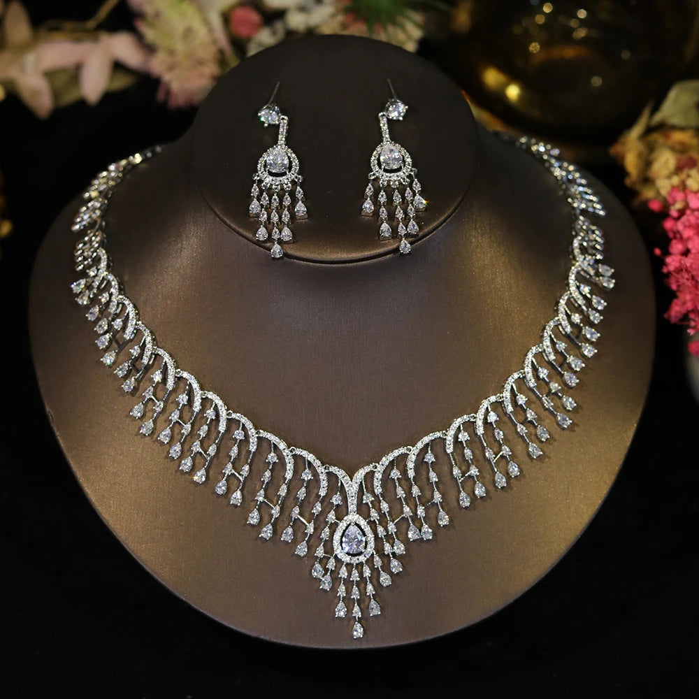 Direct front view of a sparkling cubic zirconia bridal tassel necklace and dropdown earrings on a jewelry bust.