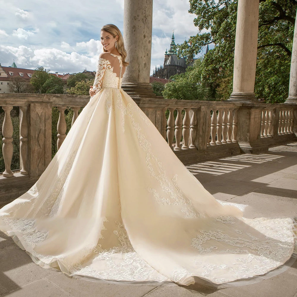 Rear perspective of a vintage-style lace wedding dress showcasing intricate lace detailing and a dramatic court train.