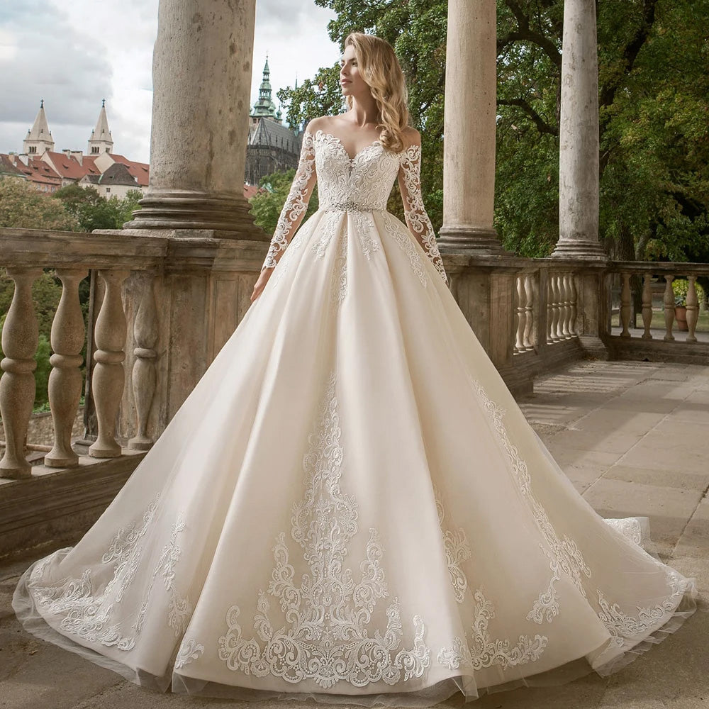 Full-length front view of an elegant long sleeve lace A-line bridal gown with a refined off-the-shoulder neckline.