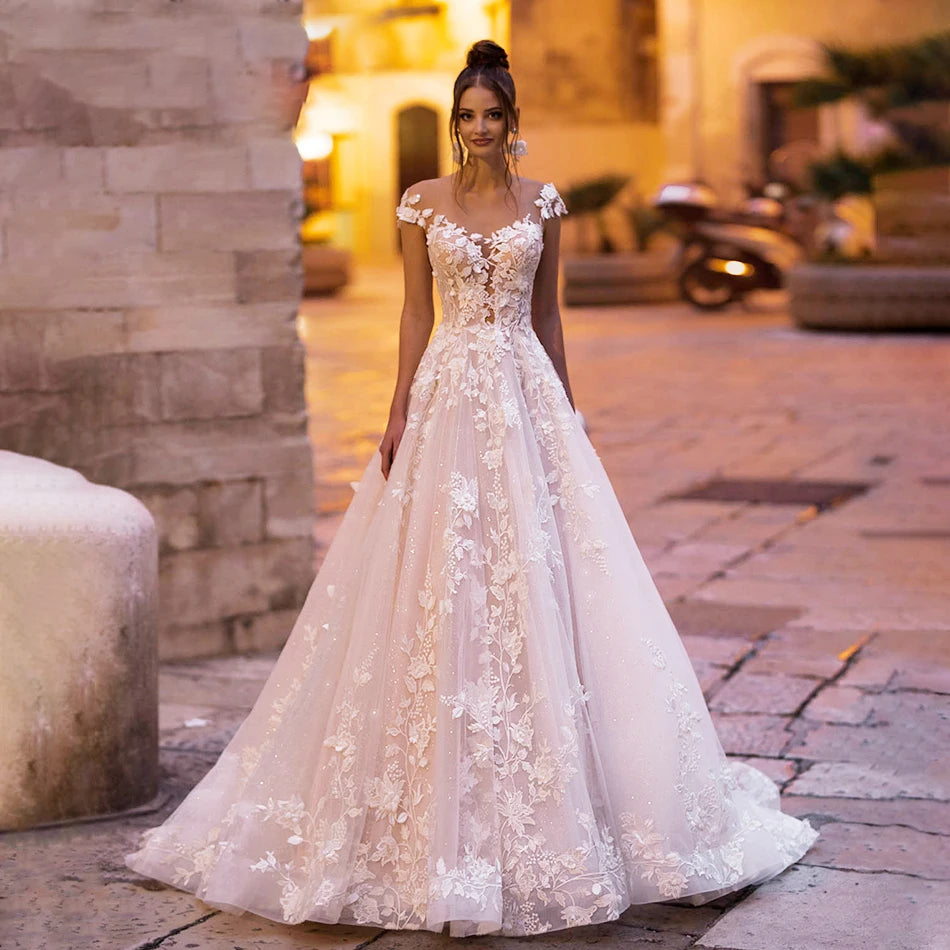 Front view of an elegant A-line wedding dress featuring intricate beaded lace appliques and a delicate illusion neckline, perfect for a romantic bridal look.