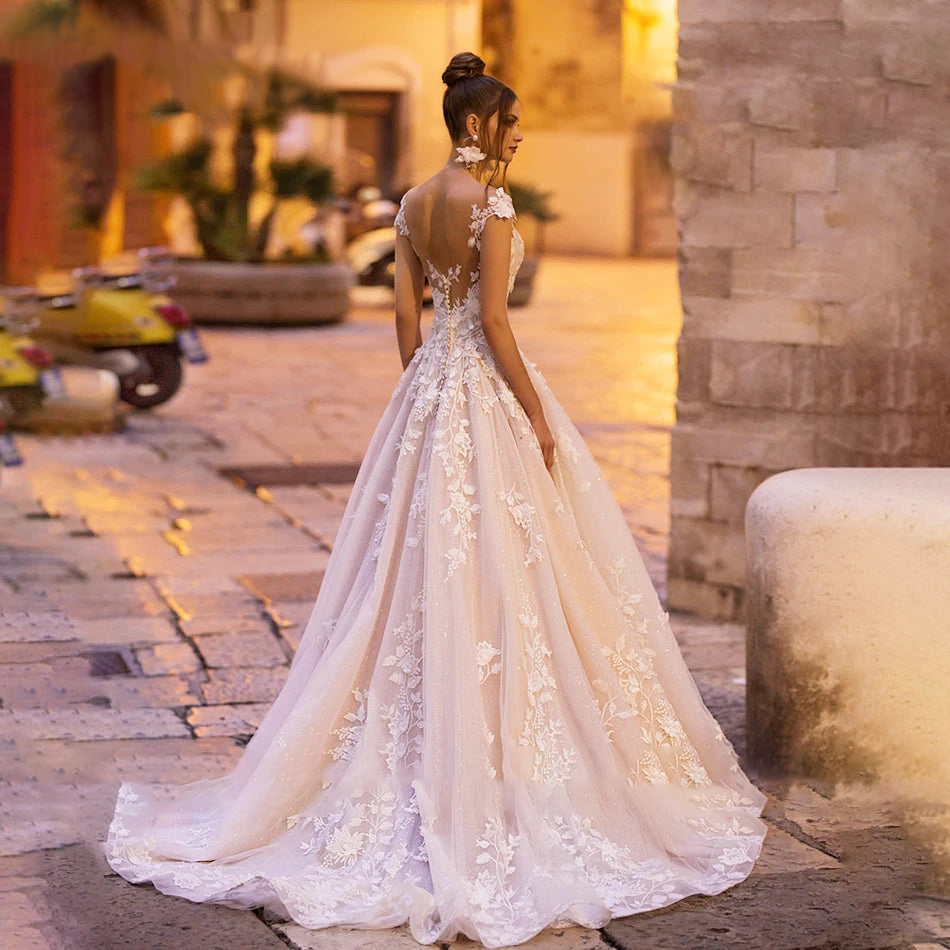 Full back view of the princess-style wedding gown, showcasing the stunning backless design with detailed lace embroidery and a flowing train.