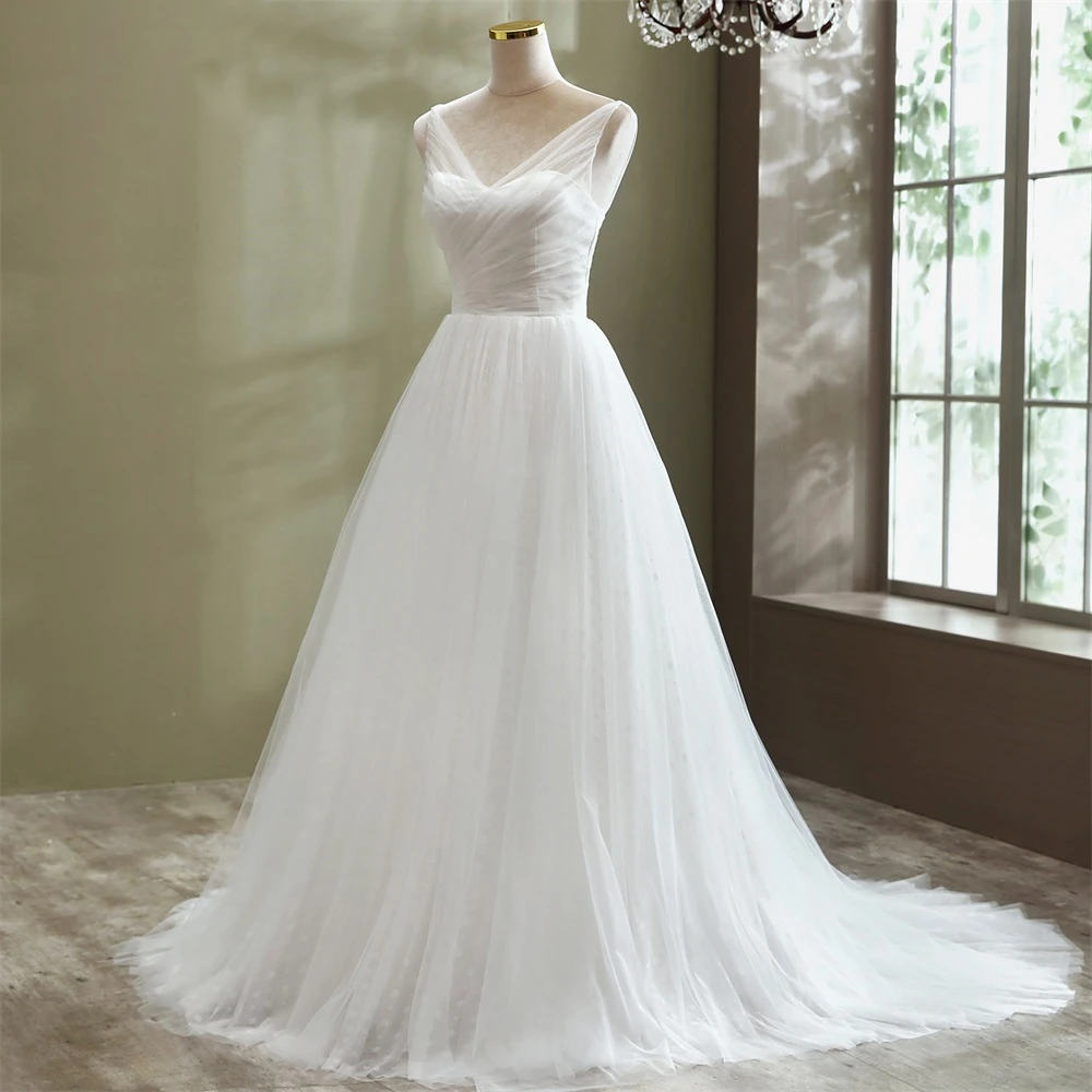Front view of a sleeveless A-line tulle wedding dress with intricate pleated bodice detailing on a mannequin.