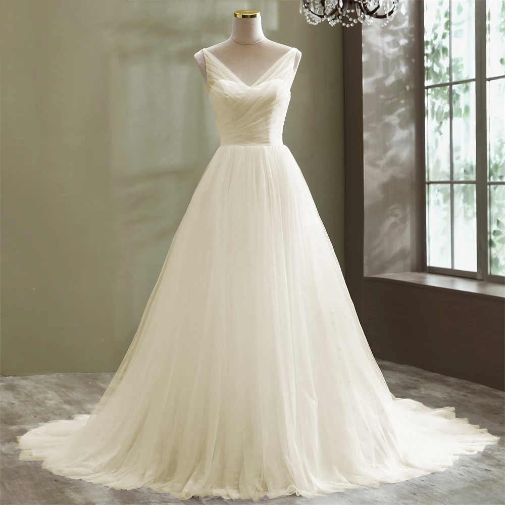 Full view of an elegant A-line tulle wedding dress, emphasizing the soft, flowy fabric ideal for a beach ceremony.