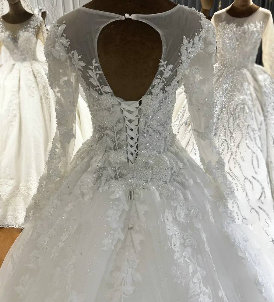 Close-up back detail of a romantic wedding dress featuring a delicate keyhole design and a traditional lace-up corset closure.
