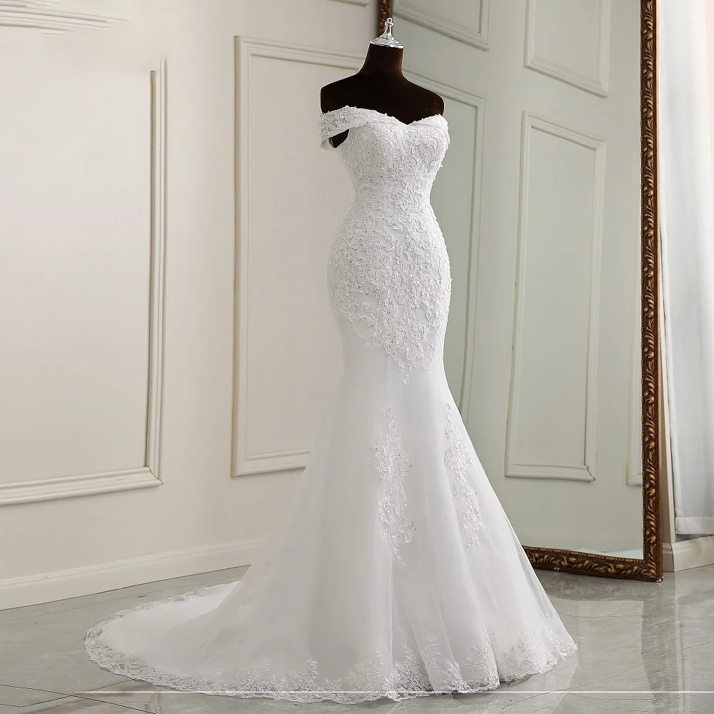 Mannequin display of an elegant off-shoulder boat neck mermaid wedding dress featuring detailed lace and beadwork.