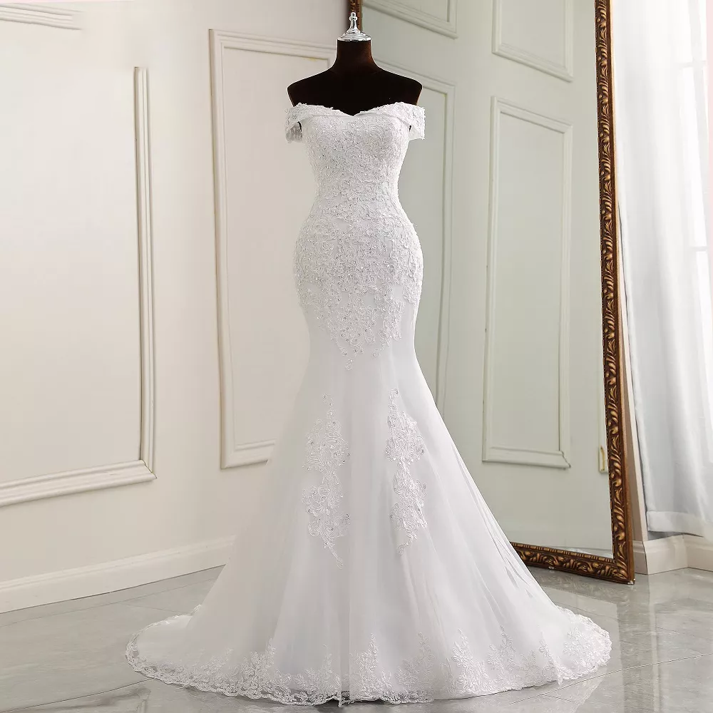 Close-up detail of the off-shoulder boat neck neckline and beaded bodice on a luxury mermaid bridal gown.