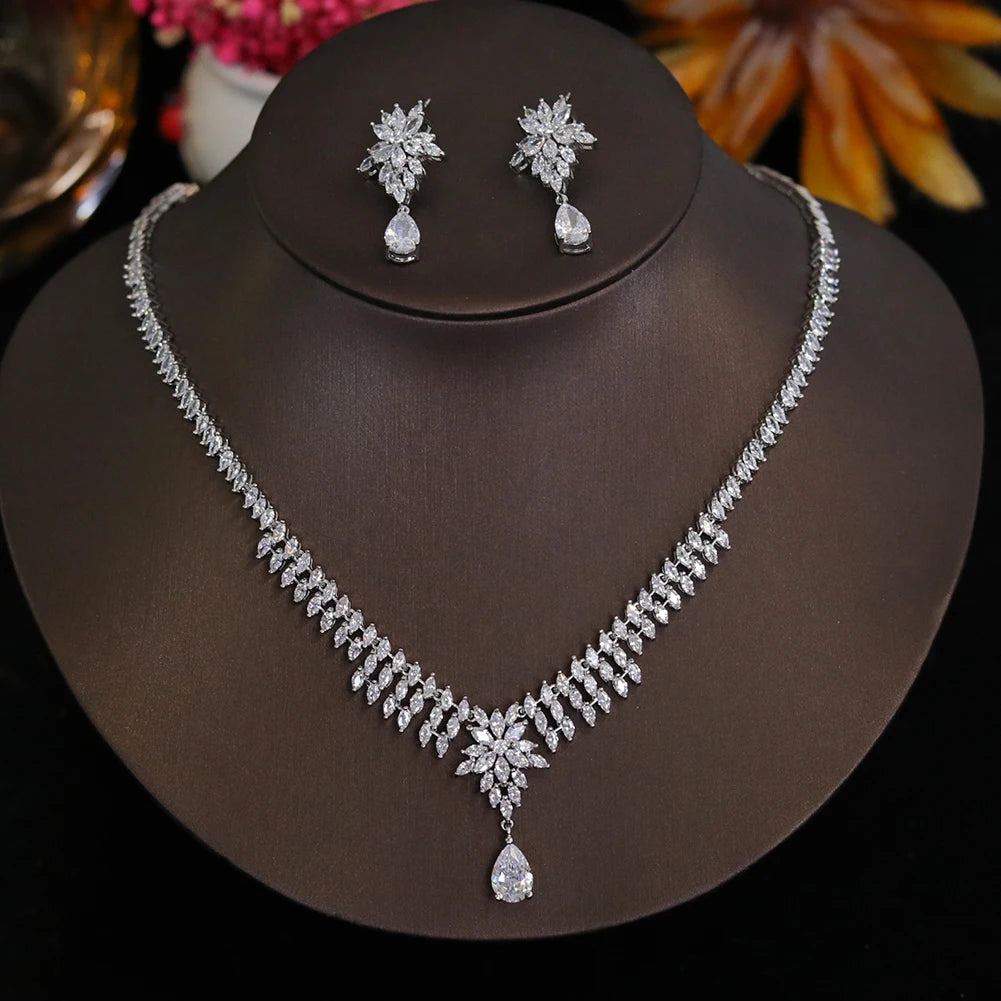 2-piece wedding jewelry set featuring a sparkling CZ necklace and floral drop earrings on a display stand
