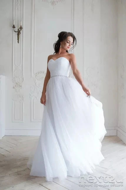 Classic white chiffon A-line wedding dress with a sweetheart neckline and delicate crystal belt for an elegant bridal look.