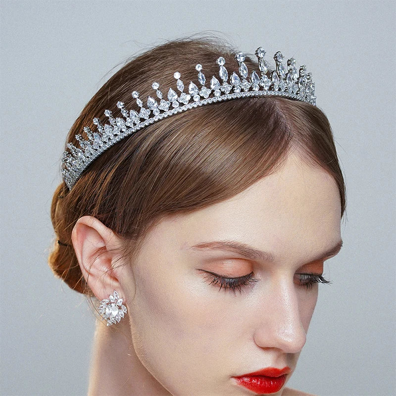 Close-up profile of a model wearing an elegant crystal bridal tiara headband with a classic wedding bun updo.