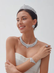 Smiling model wearing an elegant cubic zirconia bridal crown headband with matching crystal wedding necklace, earrings, and bracelet