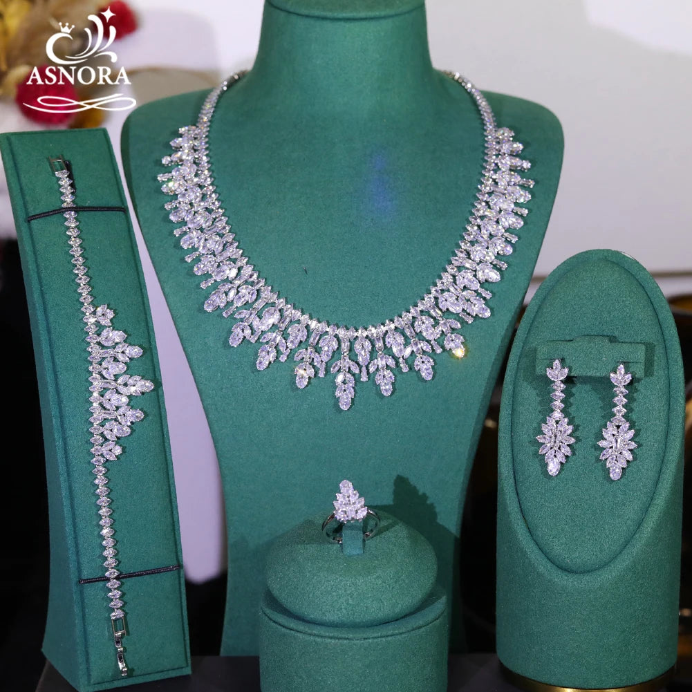 Direct front view of a luxury 4-piece wedding jewelry set including a flower marquise necklace, bracelet, earrings, and ring.