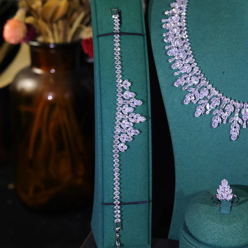 Detailed view of an elegant silver crystal flower bridal bracelet displayed on a vertical green jewelry stand.