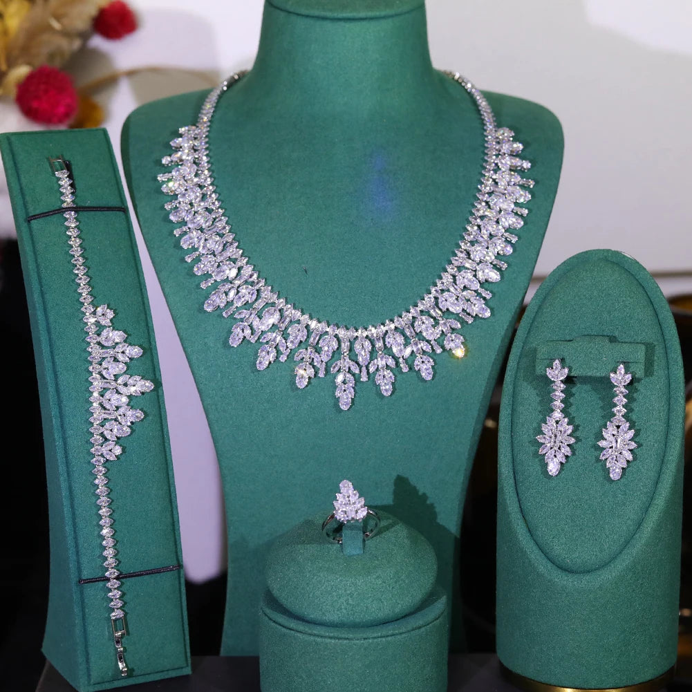 Symmetrical presentation of the 4-piece crystal wedding party accessory collection displayed on green velvet mounts.