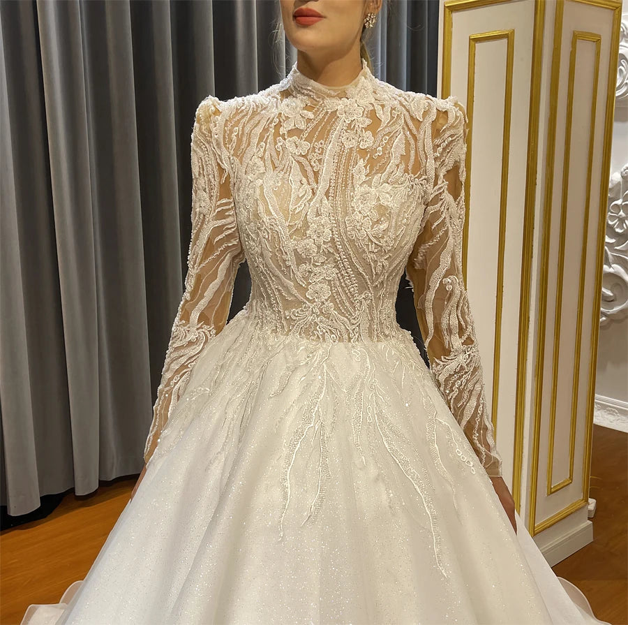 Close-up of a luxury illusion bodice on a high-neck wedding dress, showcasing intricate white lace appliques and delicate beadwork.