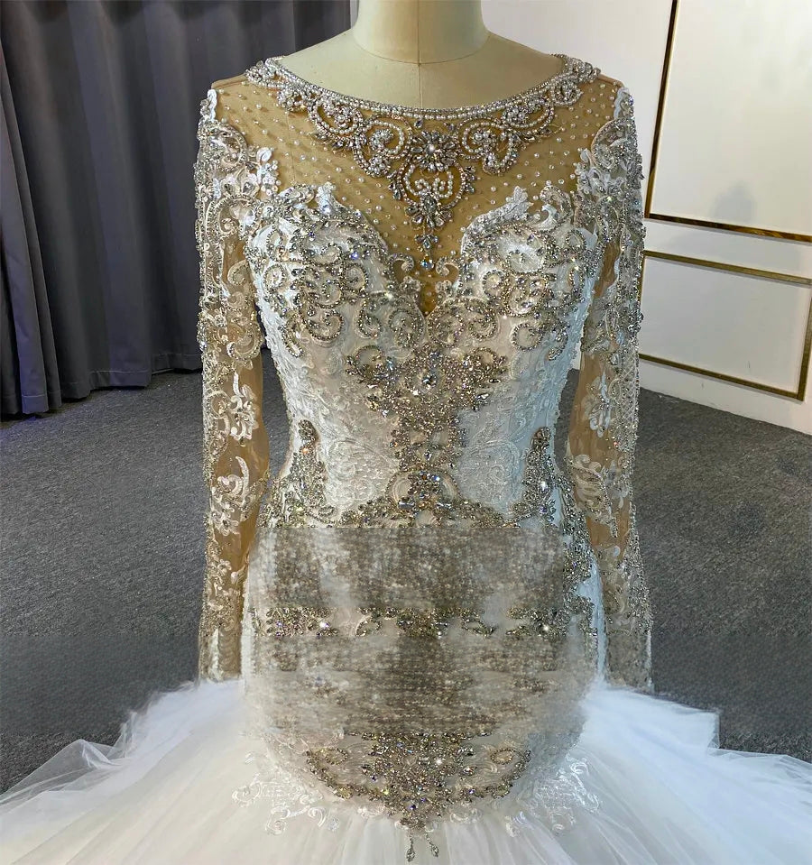 Elegant beaded evening gown on a mannequin against a neutral background