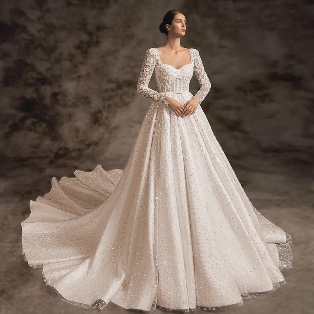 Full-length front profile of an elegant long-sleeve A-line wedding dress with scalloped lace and a regal princess silhouette.
