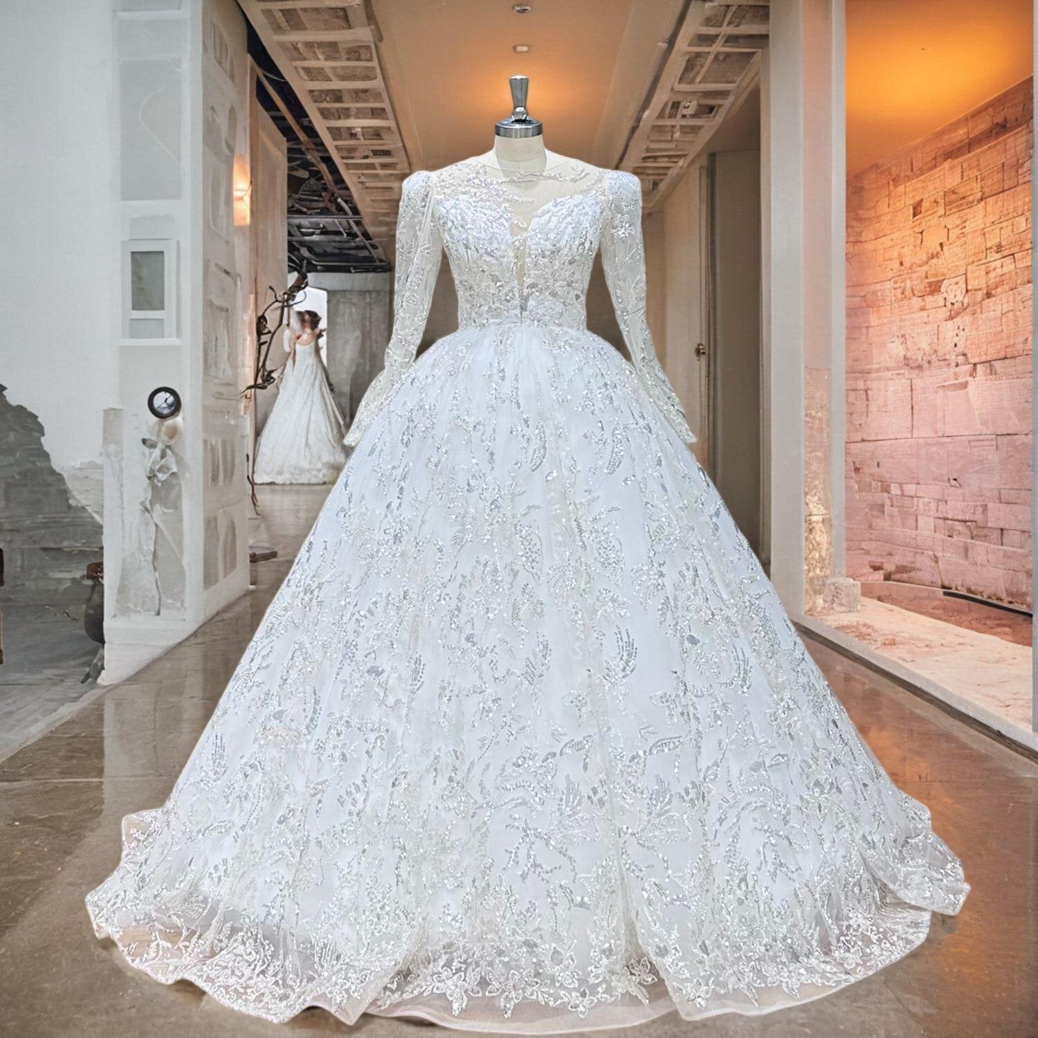 Full-length shot of a mannequin wearing an elegant long-sleeve lace ball gown wedding dress with an illusion back in a boutique hallway.