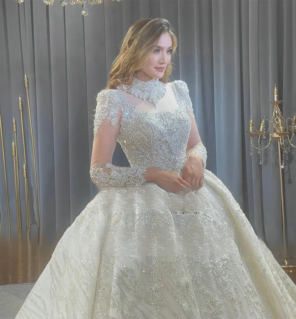 Close-up side profile of the handcrafted embroidery and luxury crystal beadwork on the high-neck bodice of a sparkling white wedding gown.