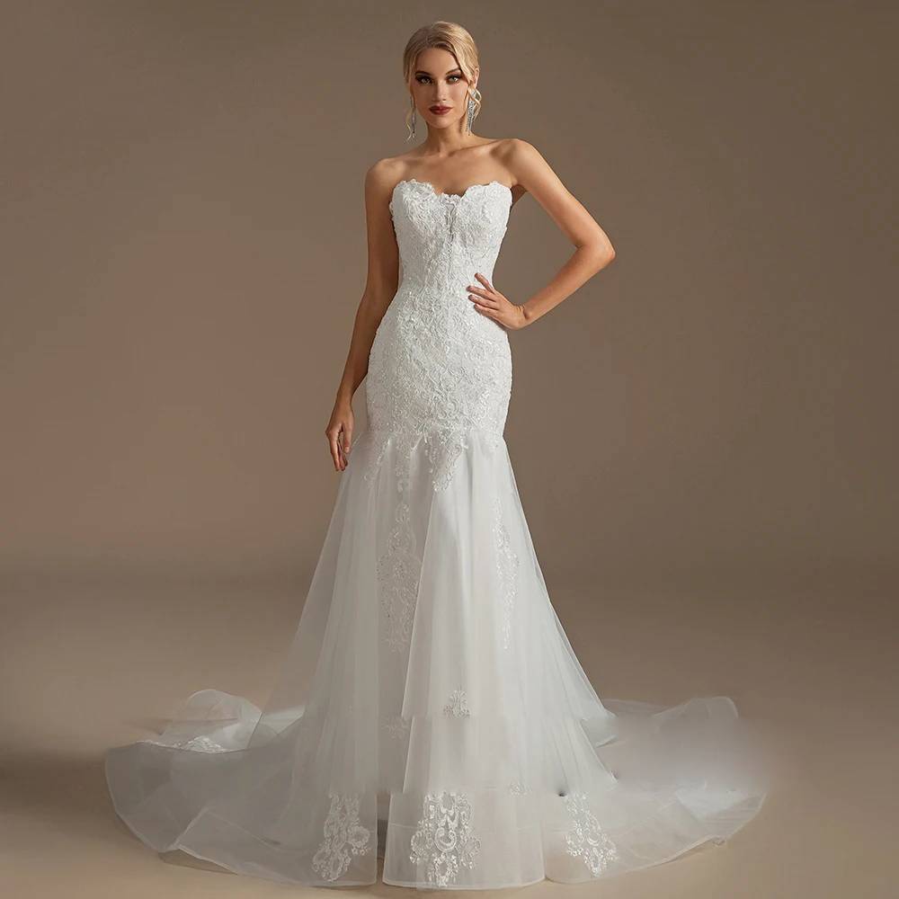 Front full-length view of a strapless mermaid wedding dress featuring an embroidered lace bodice, sweetheart neckline, and a layered tulle skirt.