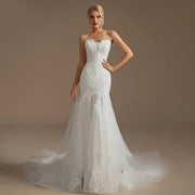 Front full-length view of a strapless mermaid wedding dress featuring an embroidered lace bodice, sweetheart neckline, and a layered tulle skirt.